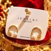 This is a simple, fashionable and elegant women's ear accessory with golden circular stud earrings and pearl zircon decoration Specification image